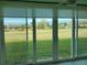 Tiled lanai boasting golf course views through large glass windows at 3790 Pinebrook Cir # 103, Bradenton, FL 34209