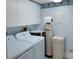 Laundry room featuring washer, dryer, water filtration system, and white cabinets at 3790 Pinebrook Cir # 103, Bradenton, FL 34209