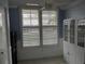 This living area has plantation shutters, allowing natural light, and a cabinet for storage and decor at 3790 Pinebrook Cir # 103, Bradenton, FL 34209
