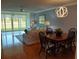 Bright living room and dining area featuring outdoor views, comfortable seating, and a dining table at 3790 Pinebrook Cir # 103, Bradenton, FL 34209