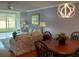 Open-concept living area with dining space, modern lighting, and comfortable seating arrangement with outdoor views at 3790 Pinebrook Cir # 103, Bradenton, FL 34209