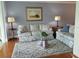 Bright living room has comfortable couches, a decorative rug, and a unique swan base glass coffee table centerpiece at 3790 Pinebrook Cir # 103, Bradenton, FL 34209