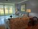 Bright living room with golf course views through expansive sliding glass doors and comfortable seating area at 3790 Pinebrook Cir # 103, Bradenton, FL 34209
