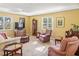Cozy living room featuring a traditional design, comfortable seating, and ample natural light at 3790 Pinebrook Cir # 103, Bradenton, FL 34209