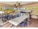 Outdoor kitchen with BBQ, countertop, tables, chairs, providing a perfect space for entertaining and dining al fresco at 3790 Pinebrook Cir # 103, Bradenton, FL 34209