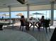Inviting outdoor dining area with shaded seating and beautiful views of the ocean at 3790 Pinebrook Cir # 103, Bradenton, FL 34209