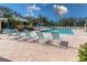 Relaxing pool area with lounge chairs and well-maintained landscaping, perfect for outdoor enjoyment at 3790 Pinebrook Cir # 103, Bradenton, FL 34209