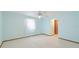 Simple carpeted bedroom featuring light blue walls, trim, and a ceiling fan at 3808 Royal Palm Dr, Bradenton, FL 34210