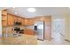 Traditional kitchen featuring stainless steel appliances, granite countertops, and wood cabinetry at 3808 Royal Palm Dr, Bradenton, FL 34210