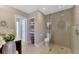 Bright bathroom featuring an open shower, modern fixtures, and built-in shelves for storage at 400 Nokomis S Ave, Venice, FL 34285