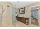Modern bathroom showcasing dual shower heads, granite counters, and earth tone walls at 400 Nokomis S Ave, Venice, FL 34285