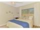 Serene bedroom with a plush bed and soft natural lighting from the window at 400 Nokomis S Ave, Venice, FL 34285