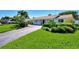 Well-maintained home with lush landscaping and inviting curb appeal at 400 Nokomis S Ave, Venice, FL 34285