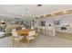 Bright, open kitchen with stainless appliances, a large island, and dining area in an airy space at 400 Nokomis S Ave, Venice, FL 34285