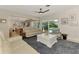 Cozy living room featuring stylish furniture, modern decor and seamless access to the outdoor pool area at 400 Nokomis S Ave, Venice, FL 34285