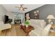 Comfortable living room with a ceiling fan and plenty of natural light at 400 Nokomis S Ave, Venice, FL 34285