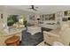 Bright living room with a modern ceiling fan, comfortable seating and access to the outdoor patio at 400 Nokomis S Ave, Venice, FL 34285