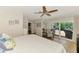 Bright main bedroom with wood floors, ceiling fan, and sliding doors leading to a patio at 400 Nokomis S Ave, Venice, FL 34285