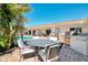 Outdoor kitchen includes a built-in grill, countertop space, and nearby seating area for entertaining by the pool at 400 Nokomis S Ave, Venice, FL 34285