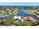 Stunning aerial view of a luxury home on a golf course with lake and lush landscaping at 4002 Las Palmas Way, Sarasota, FL 34238