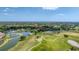 Scenic aerial view of a lush golf course community featuring water features and verdant green fairways at 4002 Las Palmas Way, Sarasota, FL 34238