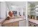 A bar with a wine rack, mini fridge, sink and glasses storage, offering an ideal space for entertaining guests at 4002 Las Palmas Way, Sarasota, FL 34238