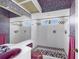 Bathroom featuring a shower and a toilet with a pink sink and colorful wall and floor tiles at 4002 Las Palmas Way, Sarasota, FL 34238