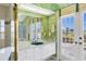 Bathroom featuring a sink, mirror, shower, and direct access to the pool at 4002 Las Palmas Way, Sarasota, FL 34238
