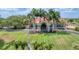 Stunning clubhouse featuring palm trees, a well-manicured lawn, and an American flag at 4002 Las Palmas Way, Sarasota, FL 34238