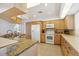 A bright kitchen with granite countertops, white appliances, ample cabinetry, and a functional layout at 4002 Las Palmas Way, Sarasota, FL 34238
