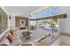 Bright living room with large windows overlooking the pool and golf course, creating a serene atmosphere at 4002 Las Palmas Way, Sarasota, FL 34238