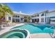 Beautiful pool and spa are surrounded by lush landscaping at 4002 Las Palmas Way, Sarasota, FL 34238