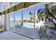 A covered lanai overlooking a private pool, the water, and golf course at 4002 Las Palmas Way, Sarasota, FL 34238