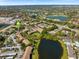 Picturesque aerial view of the condo community featuring ponds, golf course views, and meticulously maintained grounds at 4009 Crockers Lake Blvd # 25, Sarasota, FL 34238