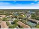 Scenic aerial view of the condo community with tennis court and lush greenery enhancing the area's appeal at 4009 Crockers Lake Blvd # 25, Sarasota, FL 34238