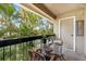 Relaxing balcony with seating, offering serene views of tropical foliage and lush landscaping at 4009 Crockers Lake Blvd # 25, Sarasota, FL 34238