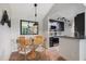 Charming dining area with modern lighting, stylish decor, and an adjacent kitchen space at 4009 Crockers Lake Blvd # 25, Sarasota, FL 34238