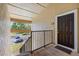 Exterior view of apartment 1225 with dark front door and stairway at 4009 Crockers Lake Blvd # 25, Sarasota, FL 34238