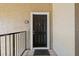 Brown front door with black hardware and a white frame, offering a welcoming entrance to the home at 4009 Crockers Lake Blvd # 25, Sarasota, FL 34238