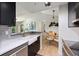 Modern kitchen featuring stainless steel appliances, sleek cabinets, stone countertops, and modern faucet and fixtures at 4009 Crockers Lake Blvd # 25, Sarasota, FL 34238