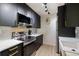 Stylish kitchen with sleek black cabinetry, stainless steel appliances, and bright stone countertops for modern appeal at 4009 Crockers Lake Blvd # 25, Sarasota, FL 34238