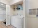 Convenient laundry area with washer, dryer, and ample storage shelving at 4009 Crockers Lake Blvd # 25, Sarasota, FL 34238