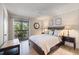 Bright main bedroom featuring a sliding glass door to a private balcony and neutral decor at 4009 Crockers Lake Blvd # 25, Sarasota, FL 34238