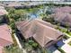 Beautiful aerial view of the home surrounded by lush landscaping, a tranquil lake, and a well-maintained community at 4015 Bridlecrest Ln, Bradenton, FL 34209