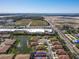 Stunning aerial view of a residential community with lush landscaping and a tranquil lake, near shopping and beaches at 4015 Bridlecrest Ln, Bradenton, FL 34209