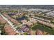 Expansive aerial shot of a residential neighborhood showcasing charming homes and serene lakes at 4015 Bridlecrest Ln, Bradenton, FL 34209