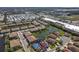 Aerial view of a residential community featuring well-maintained homes, a serene lake, and nearby shopping and amenities at 4015 Bridlecrest Ln, Bradenton, FL 34209