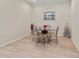 Dining room with a glass table and 4 chairs, with painting in the background at 4015 Bridlecrest Ln, Bradenton, FL 34209
