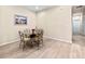 Minimalist dining room design, offering tile floors and seating for four at a glass table at 4015 Bridlecrest Ln, Bradenton, FL 34209