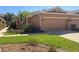 Charming home featuring a well-kept lawn and a two-car garage, complete with tasteful landscaping and exterior lighting at 4015 Bridlecrest Ln, Bradenton, FL 34209
